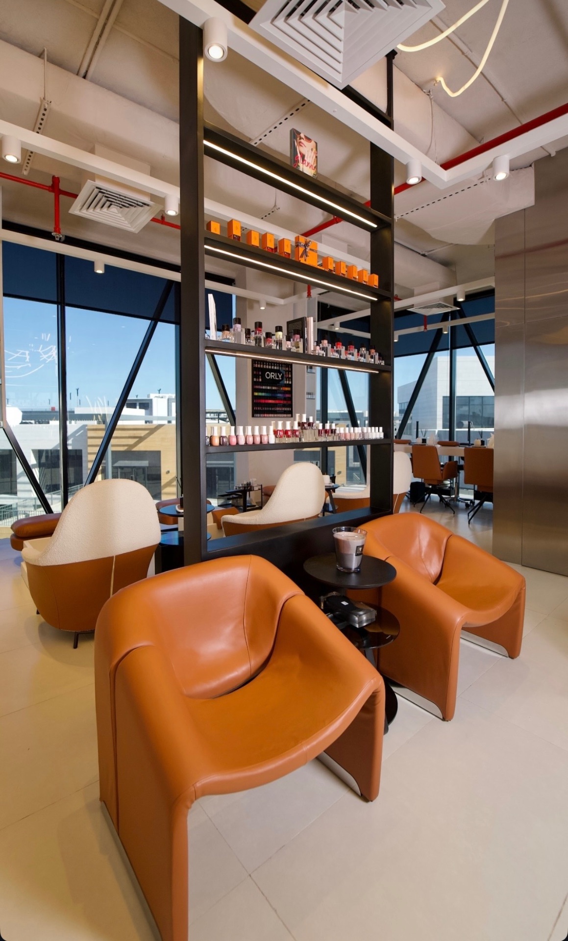 ORLY nail bar and cognac leather lounge chairs